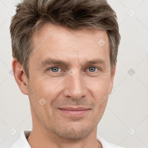 Joyful white adult male with short  brown hair and grey eyes