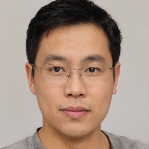 Neutral asian young-adult male with short  brown hair and brown eyes