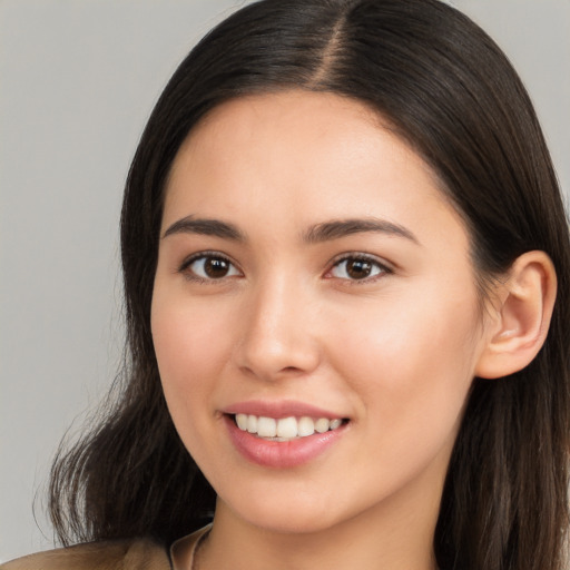 Joyful white young-adult female with long  brown hair and brown eyes