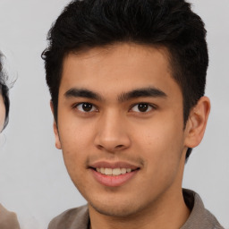 Joyful asian young-adult male with short  brown hair and brown eyes