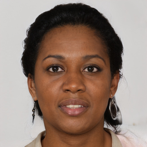 Joyful black adult female with short  black hair and brown eyes