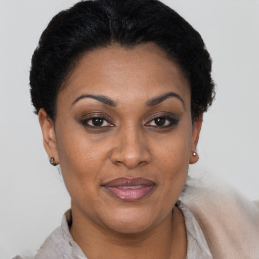 Joyful black adult female with short  brown hair and brown eyes