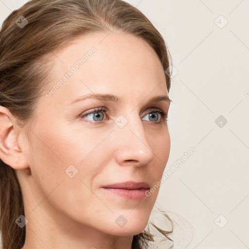 Joyful white young-adult female with long  brown hair and blue eyes