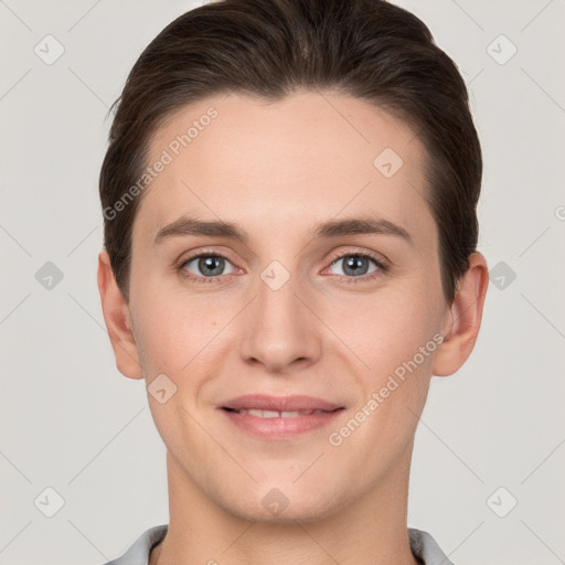 Joyful white young-adult female with short  brown hair and grey eyes