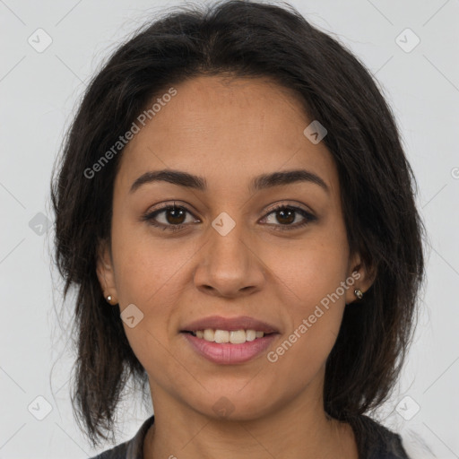 Joyful latino young-adult female with long  brown hair and brown eyes