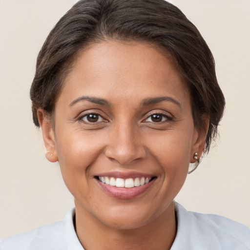 Joyful white young-adult female with short  brown hair and brown eyes