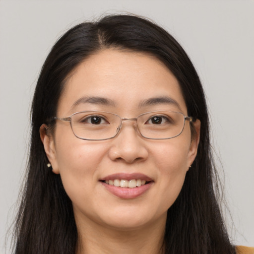 Joyful white adult female with long  brown hair and brown eyes