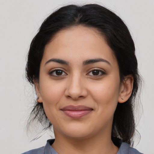 Joyful latino young-adult female with medium  brown hair and brown eyes