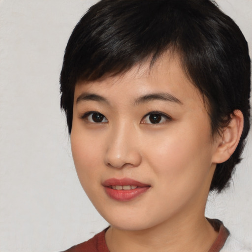Joyful asian young-adult female with medium  black hair and brown eyes