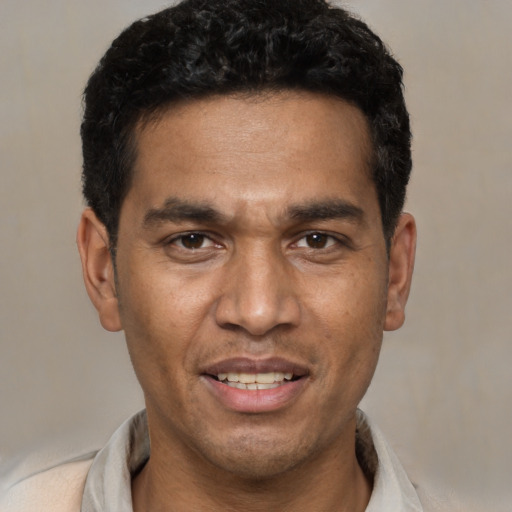 Joyful white young-adult male with short  black hair and brown eyes