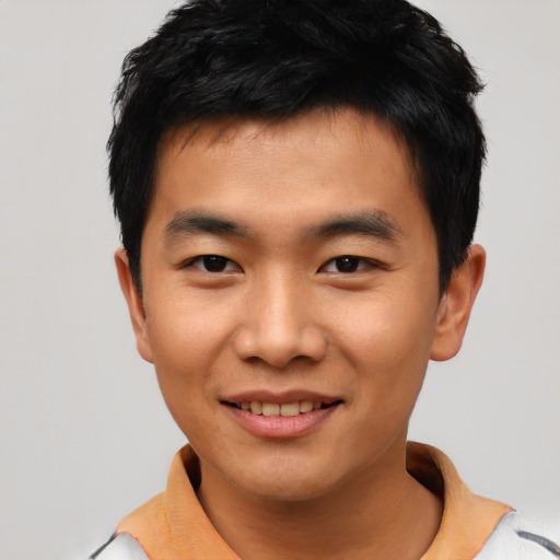 Joyful asian young-adult male with short  black hair and brown eyes