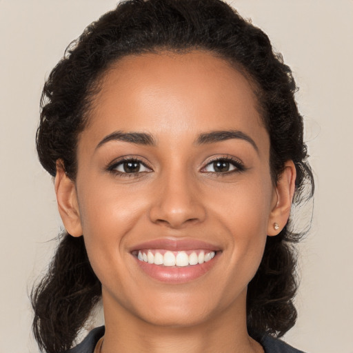 Joyful latino young-adult female with long  brown hair and brown eyes