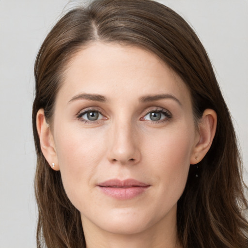 Joyful white young-adult female with long  brown hair and grey eyes