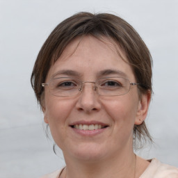 Joyful white adult female with medium  brown hair and brown eyes