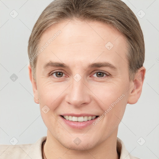 Joyful white adult female with short  brown hair and grey eyes