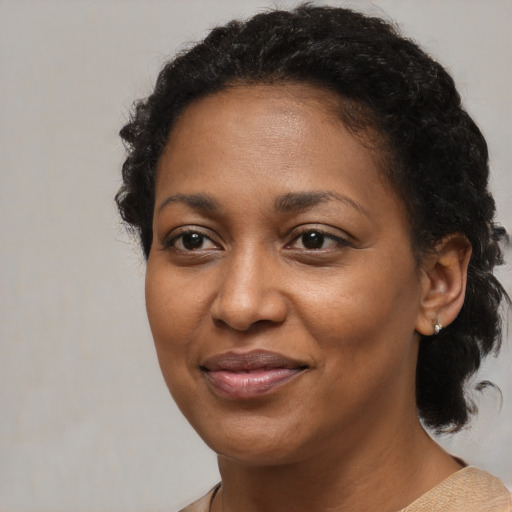 Joyful black adult female with short  brown hair and brown eyes