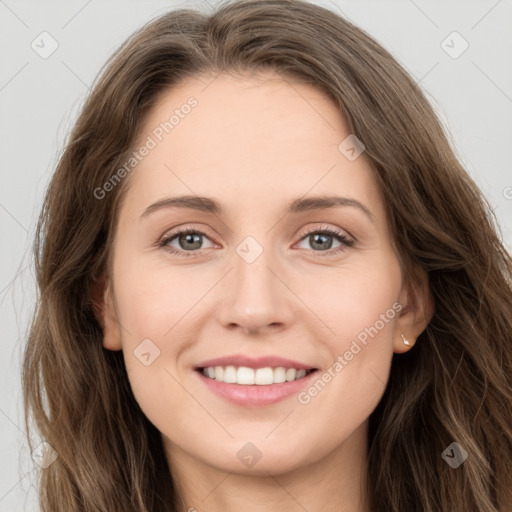 Joyful white young-adult female with long  brown hair and green eyes