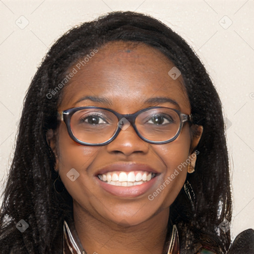 Joyful black young-adult female with long  brown hair and brown eyes