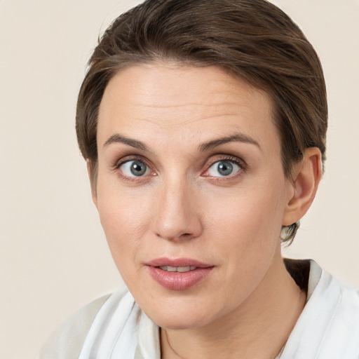 Joyful white young-adult female with medium  brown hair and grey eyes