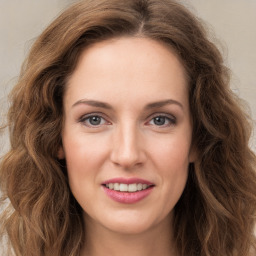 Joyful white young-adult female with long  brown hair and green eyes