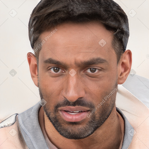 Joyful white young-adult male with short  brown hair and brown eyes