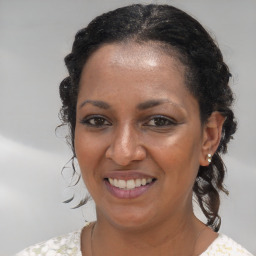 Joyful black young-adult female with medium  brown hair and brown eyes