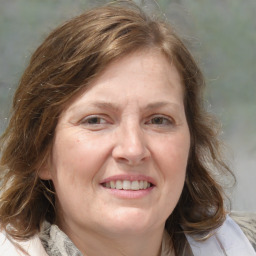 Joyful white adult female with medium  brown hair and blue eyes