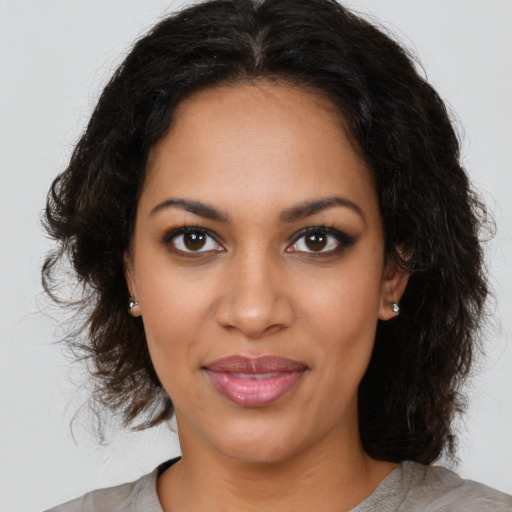 Joyful black young-adult female with medium  brown hair and brown eyes