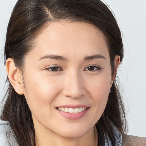 Joyful white young-adult female with medium  brown hair and brown eyes