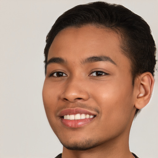 Joyful latino young-adult male with short  black hair and brown eyes