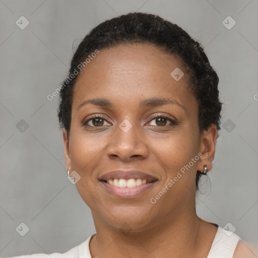 Joyful black young-adult female with short  brown hair and brown eyes