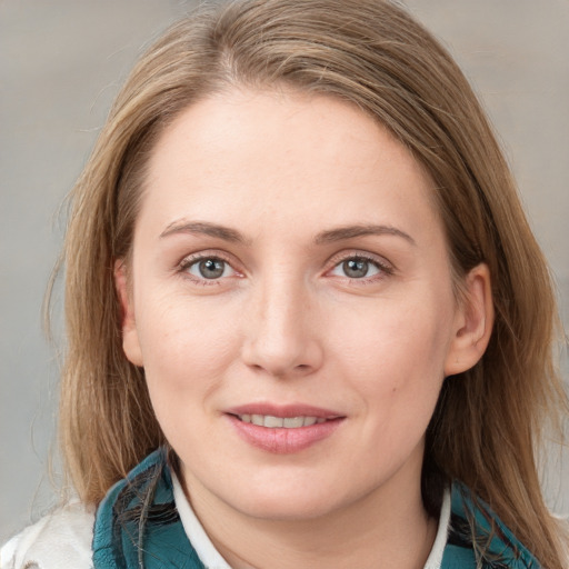 Joyful white young-adult female with medium  brown hair and blue eyes