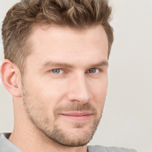 Joyful white adult male with short  brown hair and grey eyes