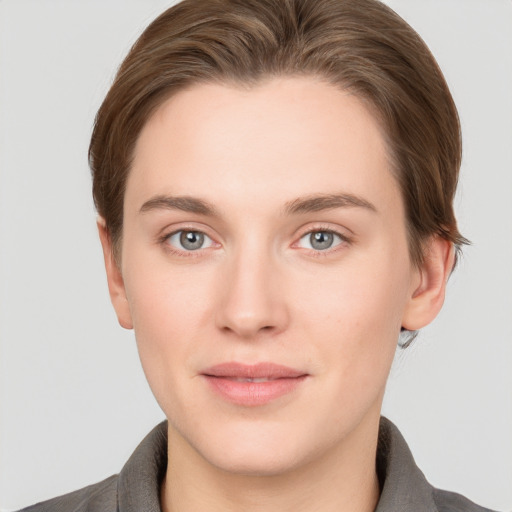 Joyful white young-adult female with short  brown hair and grey eyes