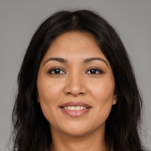 Joyful latino young-adult female with long  brown hair and brown eyes