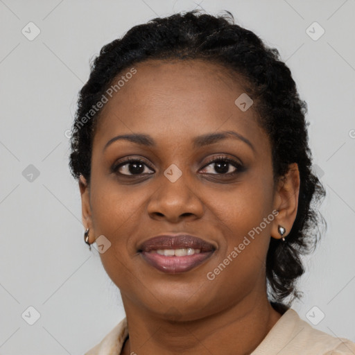 Joyful black young-adult female with short  black hair and brown eyes