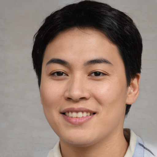 Joyful asian young-adult female with short  brown hair and brown eyes