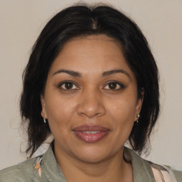 Joyful black adult female with medium  brown hair and brown eyes