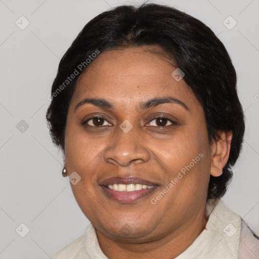 Joyful black adult female with short  brown hair and brown eyes