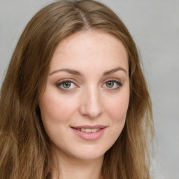 Joyful white young-adult female with long  brown hair and green eyes