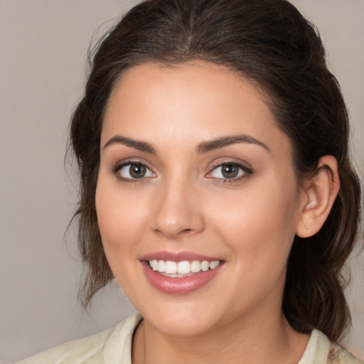 Joyful white young-adult female with medium  brown hair and brown eyes