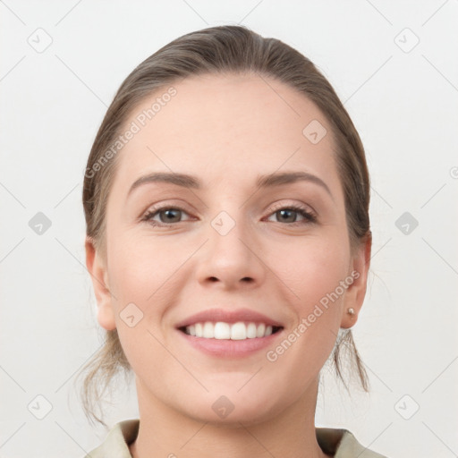 Joyful white young-adult female with medium  brown hair and grey eyes