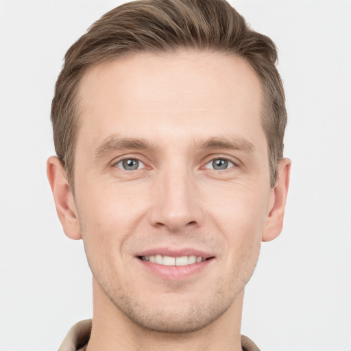 Joyful white young-adult male with short  brown hair and grey eyes