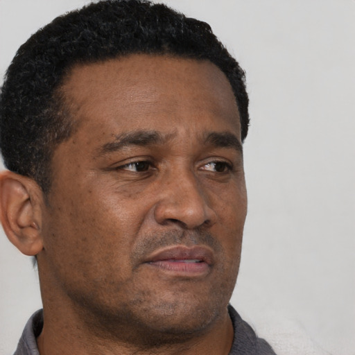 Neutral black adult male with short  brown hair and brown eyes
