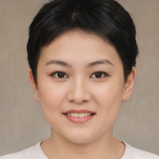 Joyful asian young-adult female with short  brown hair and brown eyes