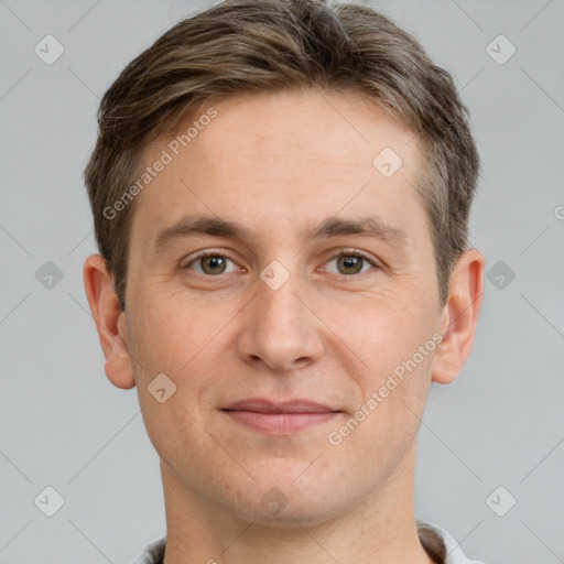 Joyful white adult male with short  brown hair and grey eyes