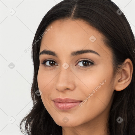 Joyful latino young-adult female with long  brown hair and brown eyes