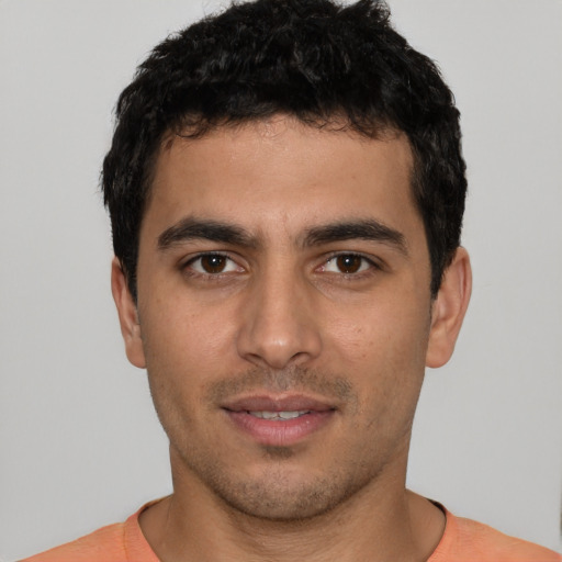 Joyful white young-adult male with short  black hair and brown eyes