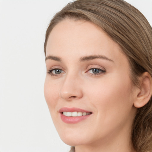 Joyful white young-adult female with long  brown hair and grey eyes