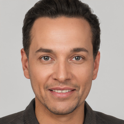 Joyful white adult male with short  brown hair and brown eyes